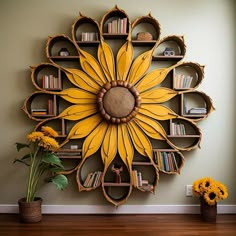 a large sunflower is on the wall next to bookshelves and vases