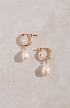 Keshi pearls dangling from high-shine hoops make a chic, modern accessory that goes with almost anything. 1 1/4" drop; 3/8" width Pearl size: 9mm Snap-post closure Due to natural variation, pearl shape and size may vary slightly 14k-gold fill/freshwater keshi pearl Made in the USA Pearl Wedding Jewelry Sets, Keshi Pearl Earrings, Playful Jewelry, Bridesmaid Pearl Earrings, Peacock Pearls, Gold Pearl Jewelry, Freshwater Pearl Jewelry, Pearl Jewelry Wedding, Fashion Scarves