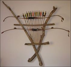 a wall mounted archery rack with arrows on it's sides and sticks sticking out of the back