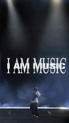 a person on a stage with the words i am music