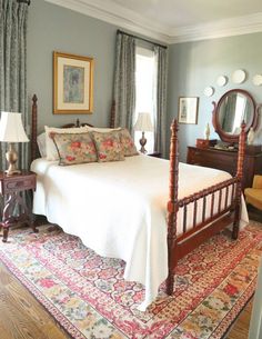 a bed sitting in a bedroom on top of a wooden floor next to a window