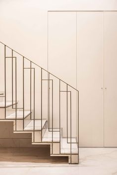 a set of white stairs in an empty room