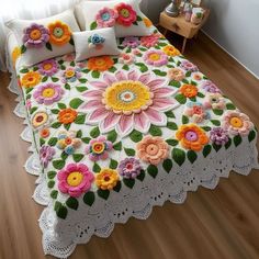 a crocheted bedspread with colorful flowers on it