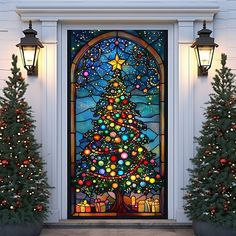 a decorated christmas tree in front of a stained glass door with holiday lights on it