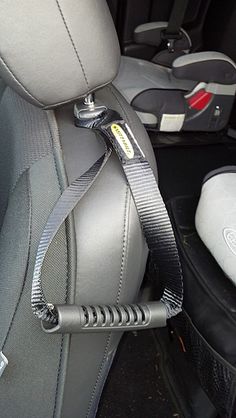 there is a seat belt attached to the back of a car's front seats