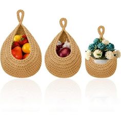 three baskets filled with fruits and vegetables sitting next to each other on top of a white surface