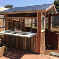 a wooden shed with a hot tub attached to it