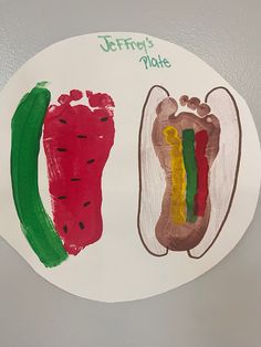 a child's hand and foot prints on a paper plate with watermelon