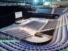 an empty auditorium filled with blue seats