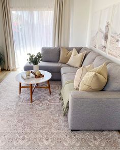 a living room filled with furniture and a large window