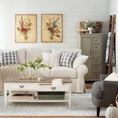 a living room filled with furniture and decor on top of a hard wood floored floor