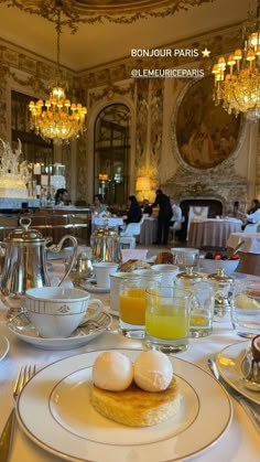 the table is set with breakfast food and silverware, including eggs, orange juice, and coffee