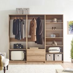 an open closet with clothes and shoes on it