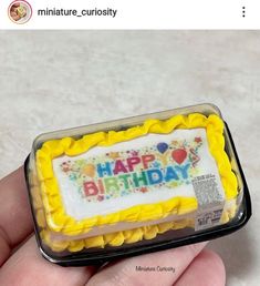 someone is holding a small birthday cake in their hand with the words happy birthday on it