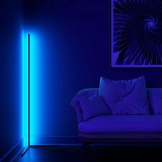 a living room with a couch and blue light in the corner, it appears to be dark