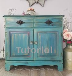 an old blue painted dresser with the word tuttoriah on it's side