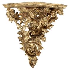 an ornate gold leaf and vine wall bracket