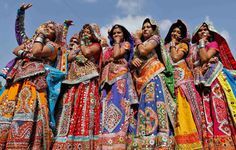 a group of women dressed in colorful clothing