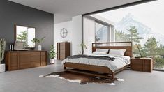 a bed room with a neatly made bed next to a window and a cowhide rug