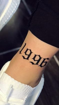 a wrist tattoo with the word hope written in cursive font on it's side