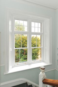 an empty room with white walls and windows