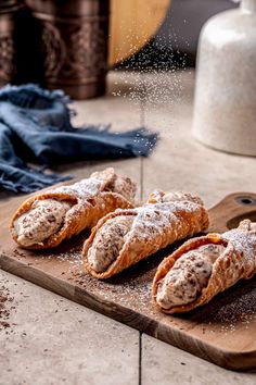 powdered sugar sprinkled on pastries sitting on a cutting board