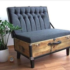 an old trunk is sitting on the floor next to a potted plant