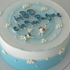 a blue and white cake with the words happy birthday on it's frosting