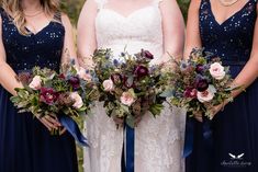 the bridesmaids are holding their bouquets with purple and red flowers on them