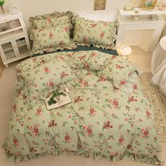 a bed with pink flowers and green sheets