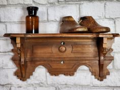 a pair of shoes sitting on top of a wooden shelf