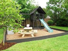 a play area in the backyard with a slide and picnic table for children to sit on