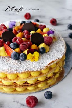 a cake covered in fruit and powdered sugar