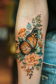 a woman's arm with a butterfly and flowers tattoo on the left side of her leg