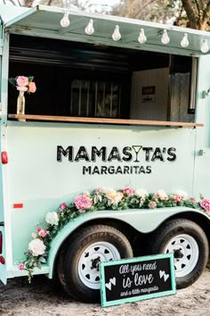 the food truck is decorated with flowers and greenery for an elegant touch to the venue