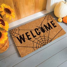 a welcome mat with sunflowers and pumpkins on the front doormat that says,'welcome '