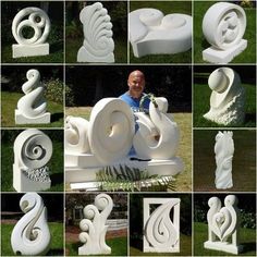 many different white sculptures are arranged on the grass and in front of a black background