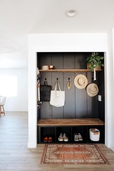 the entryway is clean and organized with hats, purses, and other items