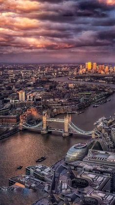 an aerial view of the city and river thames in london, england at sunset time