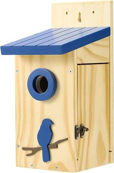 a wooden bird house with a blue roof