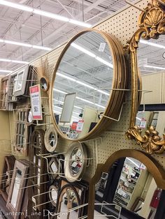 there are many mirrors on display in the store