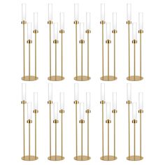 six brass and clear glass floor lamps, each with different shades on the bases in various sizes