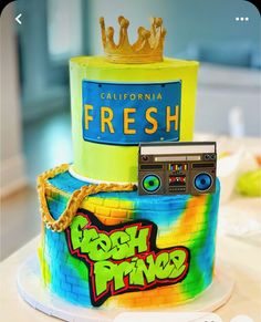 there is a colorful cake with a boombox on top and a crown on top