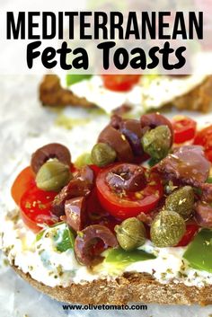 an open face sandwich with tomatoes, olives and feta cheese on toasted bread