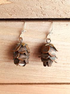 "Perfectly Cute Pine Cone Earrings These Little Cuties are Completely Hand Built from sheet metal and wire, not cast!  One of my masterpieces, I am very proud of them :) Oxidized (antiqued) Copper or Sterling Silver with a bit of Brass at the top of the pine cone hanging on hand twisted sterling silver ear wires, very realistic These earrings are modeled after the Hemlock Cone, and are life size at about 3/4\" long, the earring is about 1\" from the top of the sterling silver ear wire to the bot Pine Cone Earrings, Pinecone Earrings, Pine Cone Jewelry, Cowgirl Necklaces, Brass Pendant Necklace, Jewelry Rustic, Sand Dollar Pendant, Rustic Earrings, Earrings Nature