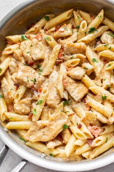 pasta with chicken and sauce in a pan