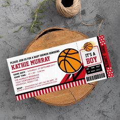 a basketball ticket sitting on top of a wooden table next to a spool of twine