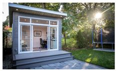 a small backyard office with sliding glass doors