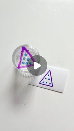 a plastic cup with some purple and blue shapes on it