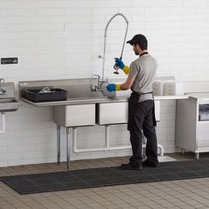 a man is washing his hands in the sink